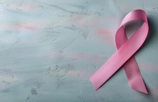 Pink Ribbon on a Light Gray Surface for Breast Cancer Awareness Month photo