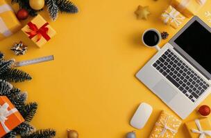 Holiday Workspace With Gifts, Christmas Decorations, and Laptop on Bright Yellow Background photo