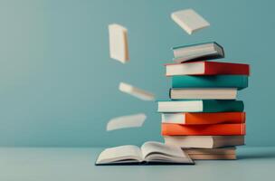 Floating Book Above Stack With Coffee Cup and Decorative Flowers in Minimalist Setting photo