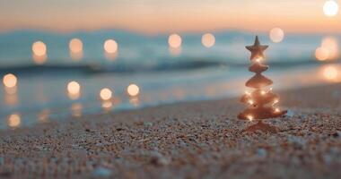 Decorative Christmas Tree on Sandy Beach at Sunset With Shimmering Lights photo