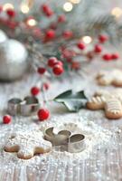 Holly Berries and Cookie Cutters on Flour photo