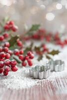 Holly Berries and Cookie Cutters on Flour photo