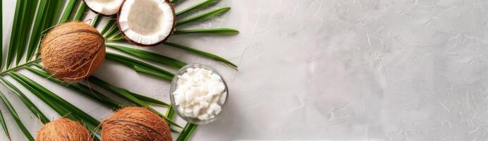 Whole and Sliced Coconuts With Palm Leaf photo