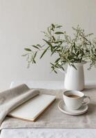 White Mug and Flowers on Table photo