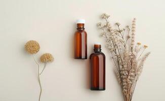 Brown Bottles And Dried Flowers On White Background photo