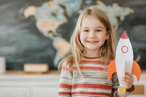 Smiling Girl Holding Paper Rocket photo