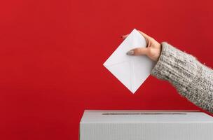 Hand Placing Ballot in Box photo