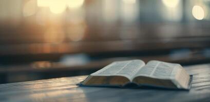 Open Bible on Wooden Table in Sunlit Room photo