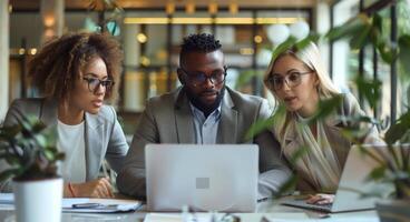 Diverse Team Working on Laptop in Modern Office photo