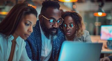 Diverse Team Working on Laptop in Modern Office photo