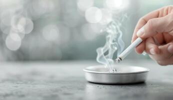 Closeup Of A Lit Cigarette Being Extinguished In An Ashtray photo