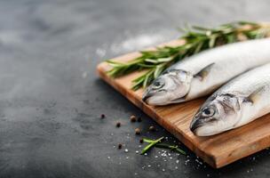 Fresh Fish On Cutting Board With Rosemary photo