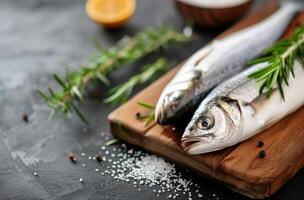Fresh Fish On Cutting Board With Rosemary photo