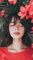 A woman is laying down in a field of red flowers photo