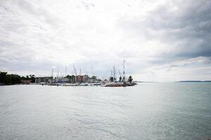 Scenic view of sailboats docked at a marina on a cloudy day in Siofok, Balaton lake, Hungary. photo
