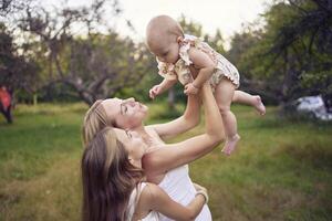 mother playing with her daughters photo