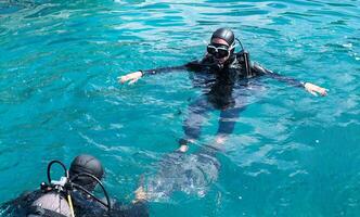Diving lessons with an instructor. First time scuba dive. Selective focus. photo