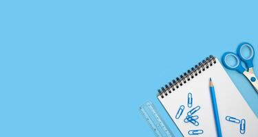 Banner with school supplies on a blue background. Back to school. Flatlay. Top view. Copy space. photo