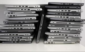 Rack with a stack of laptops in the storage room of a company photo