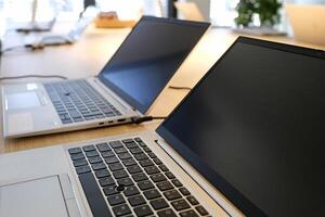 Laptop on a table in a coworking space photo