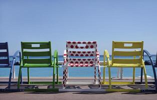 Colorful chairs at the coast of Nice, France, in the colors of the Tour de France jerseys photo