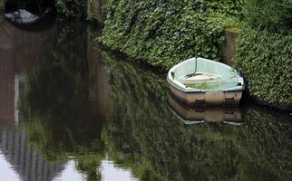 Weathered boat on the water in Amersfoort, Netherlands photo