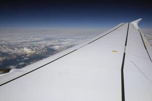 Beautiful view of the mountain range of the European Alps seen from a plane photo
