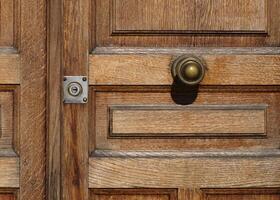 Closed wooden door with metal handle and key hole photo