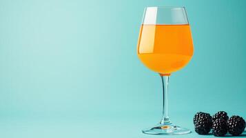 An orange wine glass with blackberries on a blue background photo