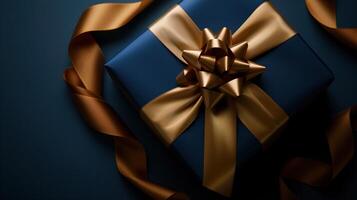 Dark blue gift box with elegant gold ribbon photo