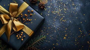 Dark gradient gift box with elegant gold ribbon on dark background photo