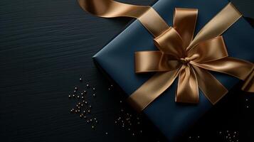 Dark blue gift box with elegant gold ribbon photo