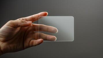 A mockup featuring a hand holding a blank translucent card photo