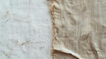 Close Up of White and Beige Linen Fabric With Frayed Edge photo
