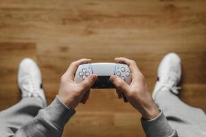 Hand hold new joystick. Gamer play game with gamepad controller. Gaming man holding simulator joypad. Person with keypad joystic in arms. happy to win. Gaming concept. photo