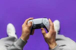 Hand hold new joystick. Gamer play game with gamepad controller. Gaming man holding simulator joypad. Person with keypad joystic in arms. happy to win. Gaming concept. photo