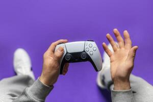 Hand hold new joystick isolated. Gamer play game with gamepad controller. Gaming man holding simulator joypad. Person with keypad joystic in arms. not understanding the situation. Gaming concept. photo