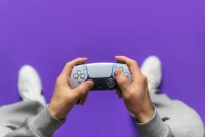 Hand hold new joystick. Gamer play game with gamepad controller. Gaming man holding simulator joypad. Person with keypad joystic in arms. happy to win. Gaming concept. photo