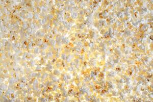 White fresh popcorn lying evenly on the surface. Popcorn back photo