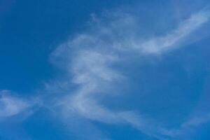 White clouds on a back of blue sky. Clear sky with fluffy light clouds. photo