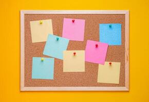 multicolored corkboard stickers pinned with buttons. yellow background. photo