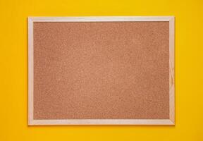 multicolored corkboard stickers pinned with buttons. yellow background. photo