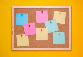 multicolored corkboard stickers pinned with buttons. yellow background. photo