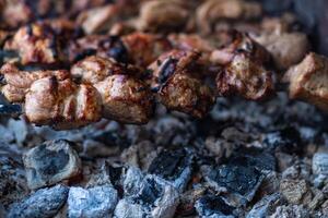 Fresh shish kebab on skewers is fried on the grill. Grilled meat on skewers. photo