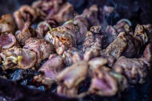 Grilled meat on skewers. Fresh shish kebab on skewers is fried on the grill. Cooking. photo