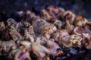 Fresh shish kebab on skewers is fried on the grill. Grilled meat on skewers. photo