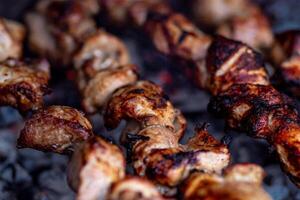 Fresh shish kebab on skewers is fried on the grill. Grilled meat on skewers. photo