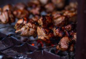 Grilled meat on skewers. Fresh shish kebab on skewers is fried on the grill. Cooking. photo