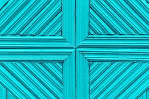 Light blue wooden background made of planks tightly knitted together. Simple geometric pattern with cross and diagonal lines. photo