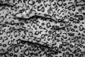 Soft fleecy faux fabric with a mottled pattern. Light leopard texture. photo